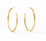 Gold hoop earrings with small white pearl accents