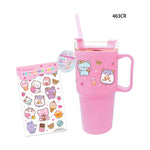 Hot Focus pink plastic tumbler and vinyl sticker sheet showing a kawaii animal-themed Design My Own kit featuring a light pink travel mug with a handle and straw decorated with a blue bear holding a cupcake and a purple hamster alongside a sheet of glittery vinyl stickers depicting various dessert-eating animals like cats bears and rabbits