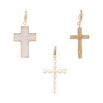 Three gold-toned cross-shaped dangle earrings displayed on a white background one featuring a white mother-of-pearl inlay another solid brushed gold and the third crafted from small white pearls