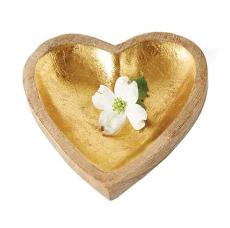 Heart-shaped gold dish with a white flower on a white background