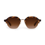 Product photograph of hexagonal sunglasses featuring a tortoiseshell upper frame, gold metal lower frame, and brown gradient lenses on a white background