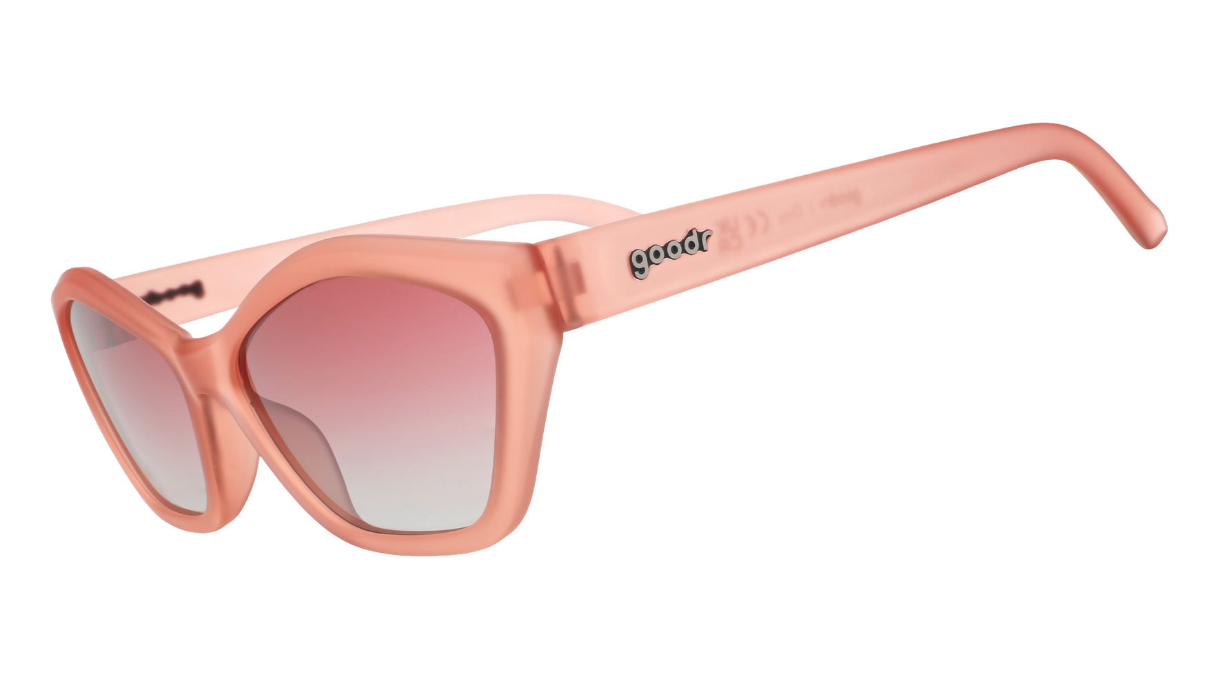 Product photo, goodr matte peachy pink cat-eye sunglasses with gradient pink to light blue-grey lenses and a silver goodr logo on the temple