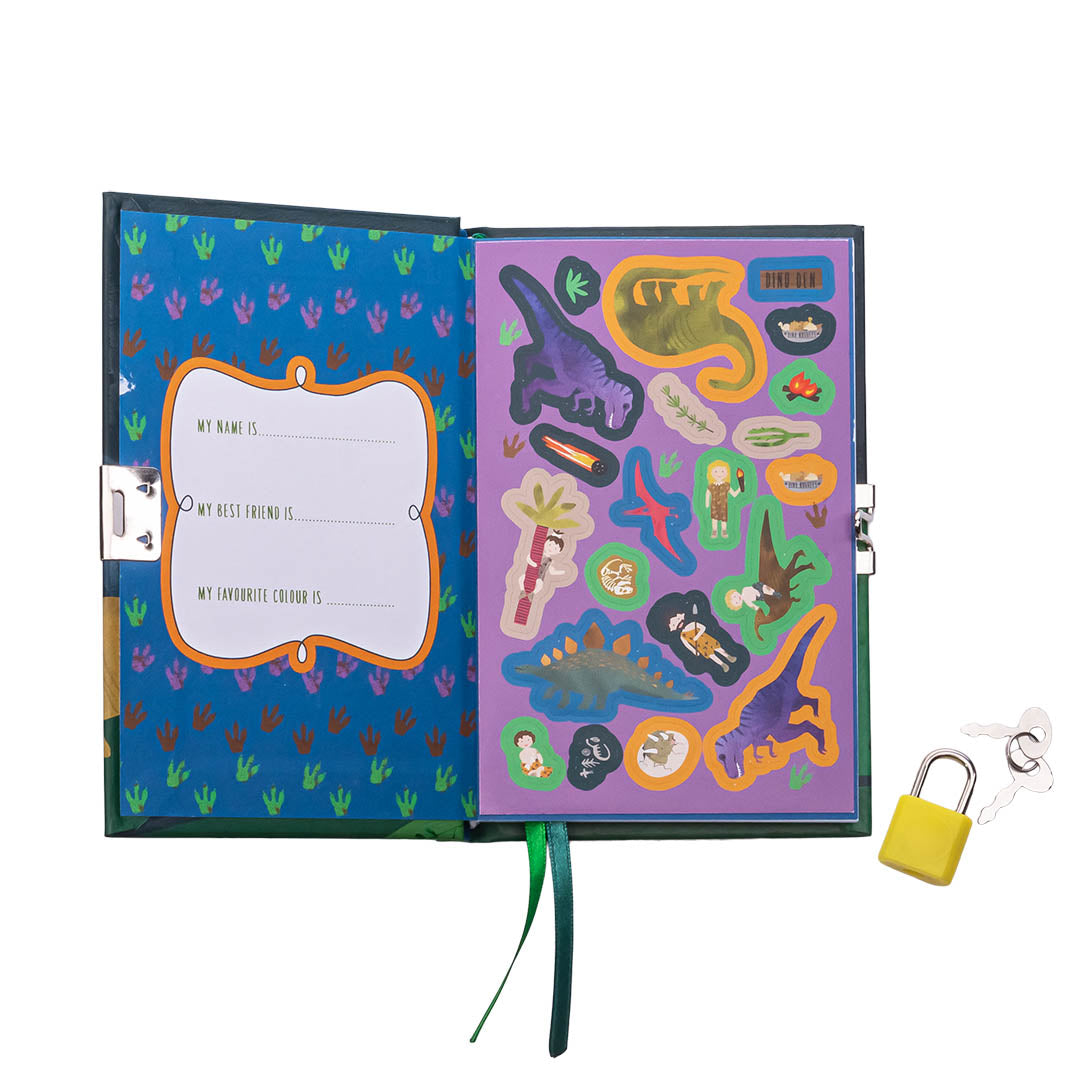 An open children's dinosaur-themed diary with a blue left page featuring purple footprints and fill-in-the-blank lines, a purple right page filled with colorful dinosaur and caveman stickers, a green ribbon bookmark, and a yellow padlock with keys resting nearby