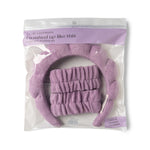 Digital photograph of a Lemon Lavender I washed up like this super soft dryband set featuring one chunky lavender purple terry cloth headband and two matching scrunchie wristbands in clear plastic packaging