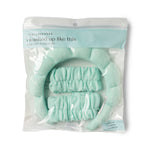 Product photography of a Lemon Lavender i washed up like this super soft dryband set in clear packaging featuring a pale mint green padded headband and two matching ruffled wristbands on a white background