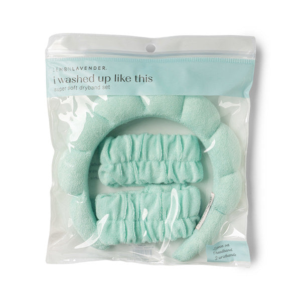 Product photography of a Lemon Lavender i washed up like this super soft dryband set in clear packaging featuring a pale mint green padded headband and two matching ruffled wristbands on a white background