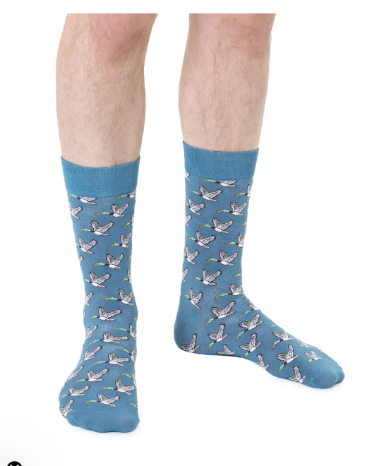 Blue crew socks with a repeating mallard duck pattern worn on legs