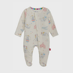 Gunamuna Disney Dumbo cream footed baby sleepsuit featuring an all-over pattern of flying Dumbo, Dumbo on a ball, circus tents, bunting, a vibrant rainbow-striped collar, and an eco-friendly label