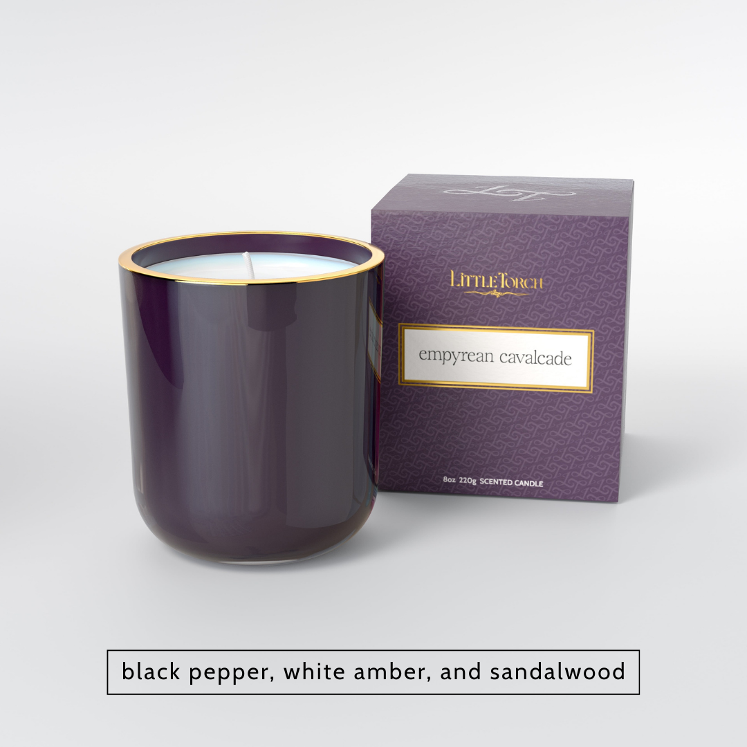Purple glass candle with gold rim and matching patterned box labeled Empyrean Cavalcade