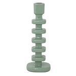 Glazed sage green ceramic candlestick holder featuring a tall column of stacked geometric rectangular segments