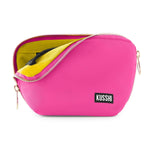 Product photography KUSSHI vibrant fuchsia makeup bag half-open revealing bright yellow interior lining a black elastic loop and a KUSSHI logo patch