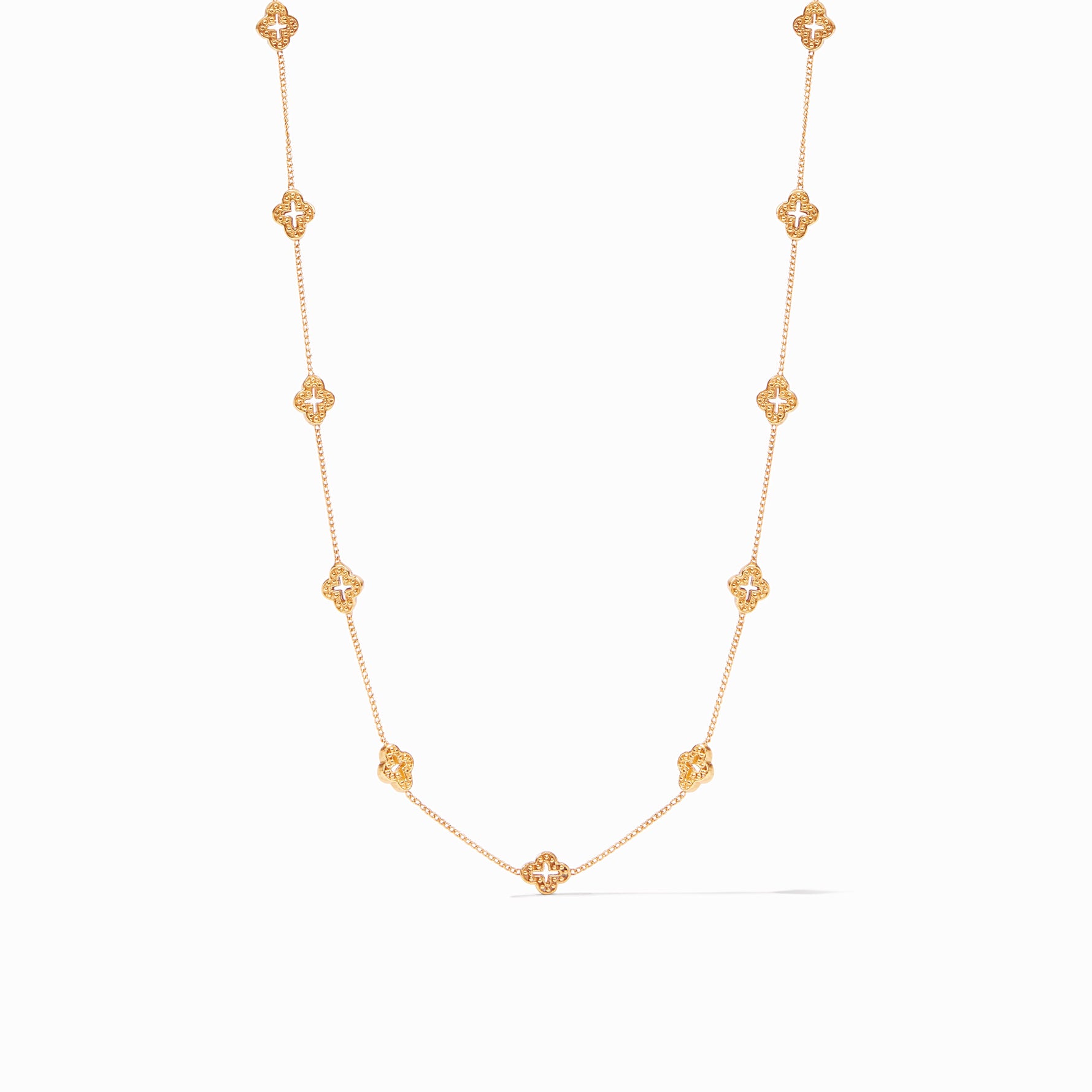 Gold chain necklace featuring nine evenly spaced clover shaped charms