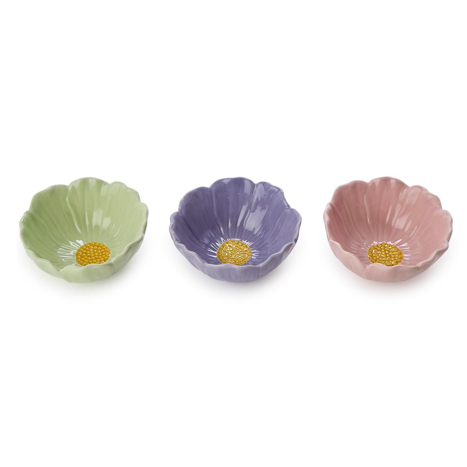 A set of three ceramic flower-shaped bowls in light green lavender and pink each featuring a textured yellow center