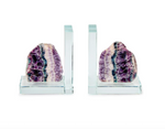 Fluorite and glass bookends featuring raw mineral specimens with vibrant purple and teal crystalline banding mounted on polished clear L-shaped supports against a white background