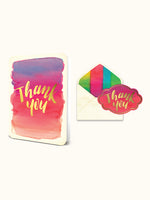 Thank you greeting card with watercolor gradient and gold lettering next to an envelope with a colorful liner