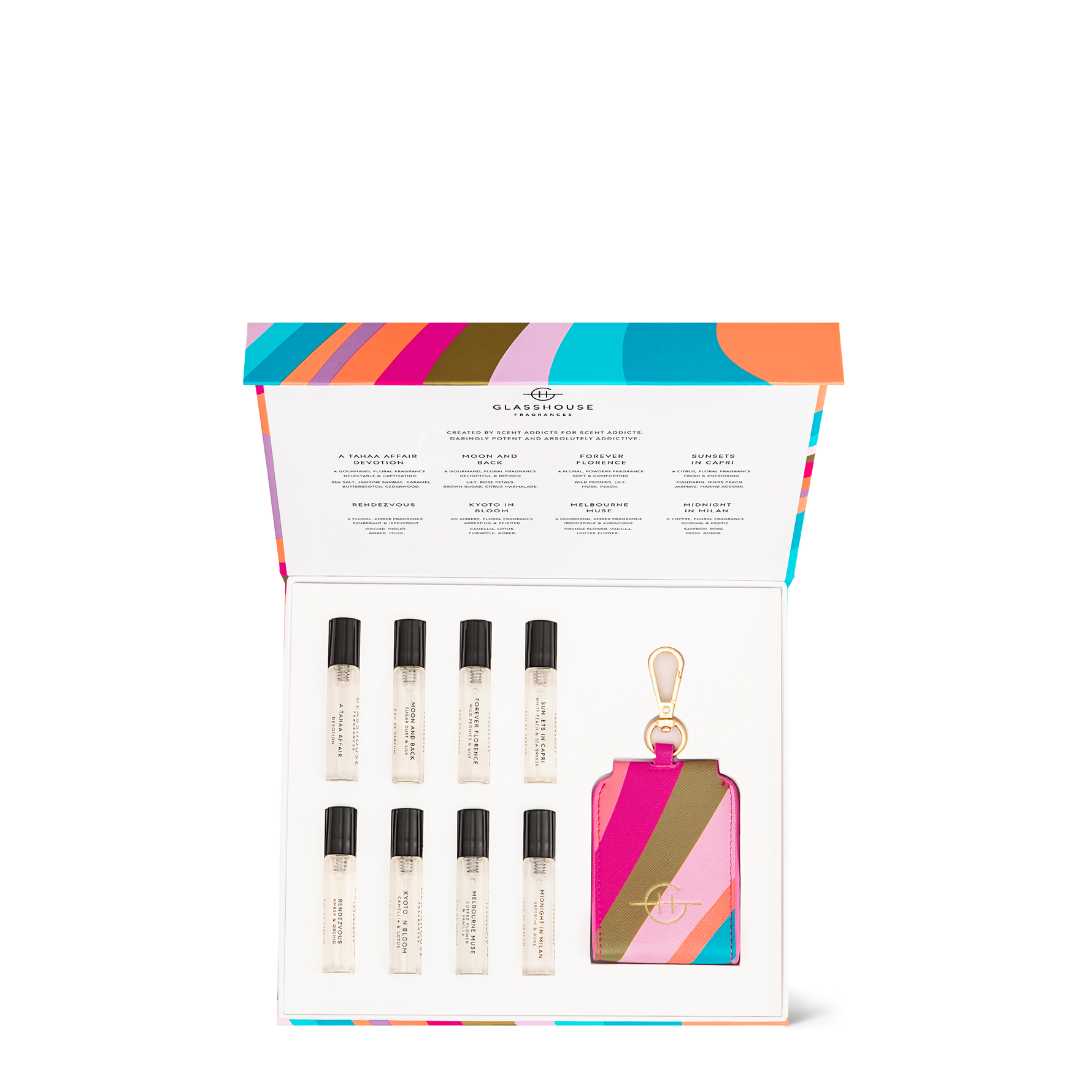 Product photography by Glasshouse Fragrances, a luxury fragrance discovery set featuring eight miniature travel perfumes with names like Forever Florence and Midnight in Milan, presented in an in an open white box with a vibrant multi-colored striped lid and a matching keyring holder with gold hardware