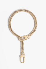 Gold-toned jewelry by Marvin Costello a chunky cuban link chain forms an elegant loop with a hanging D-ring clasp displaying brand engraving against a white studio background