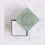 Open box of Gatherings conversation cards surrounded by individual prompt cards