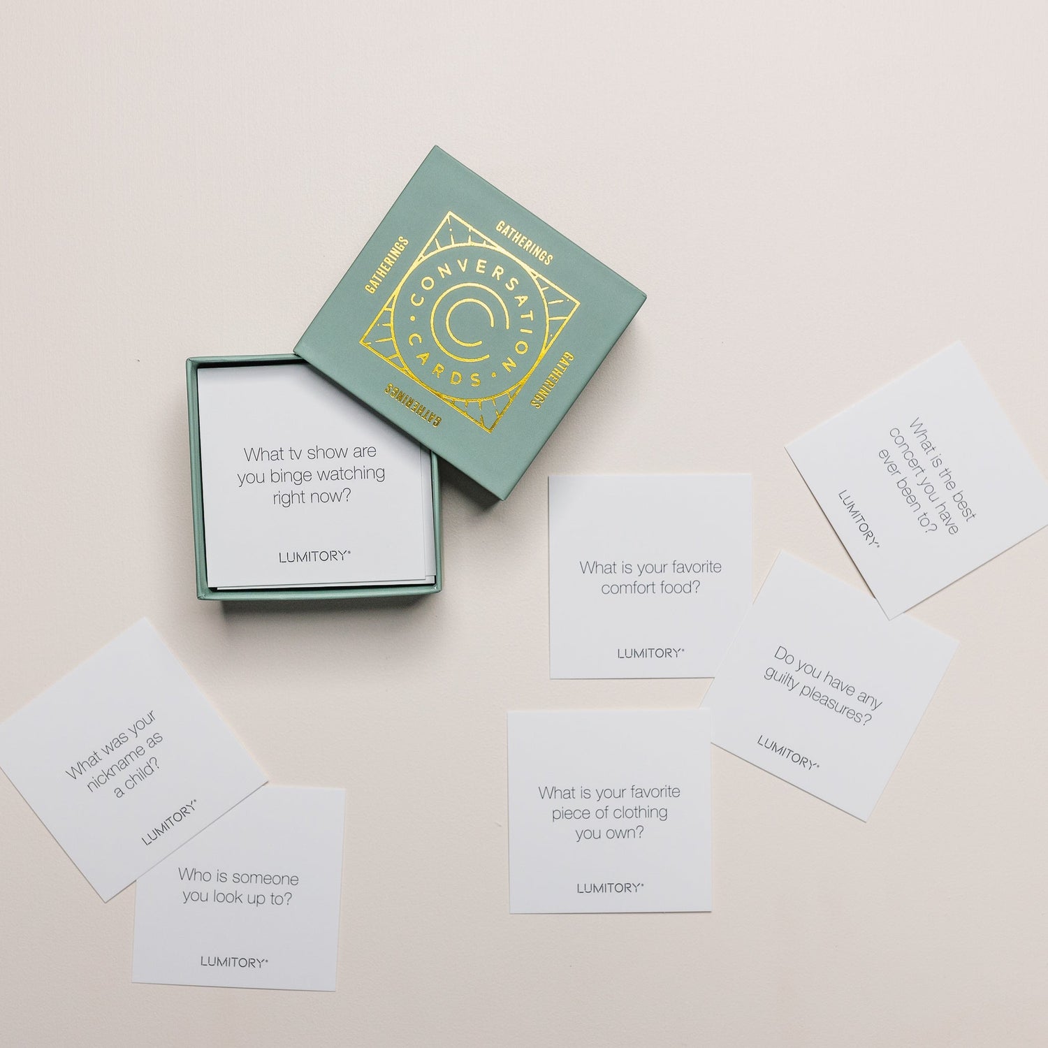 Lumitory conversation cards box with several prompt cards scattered on a light surface