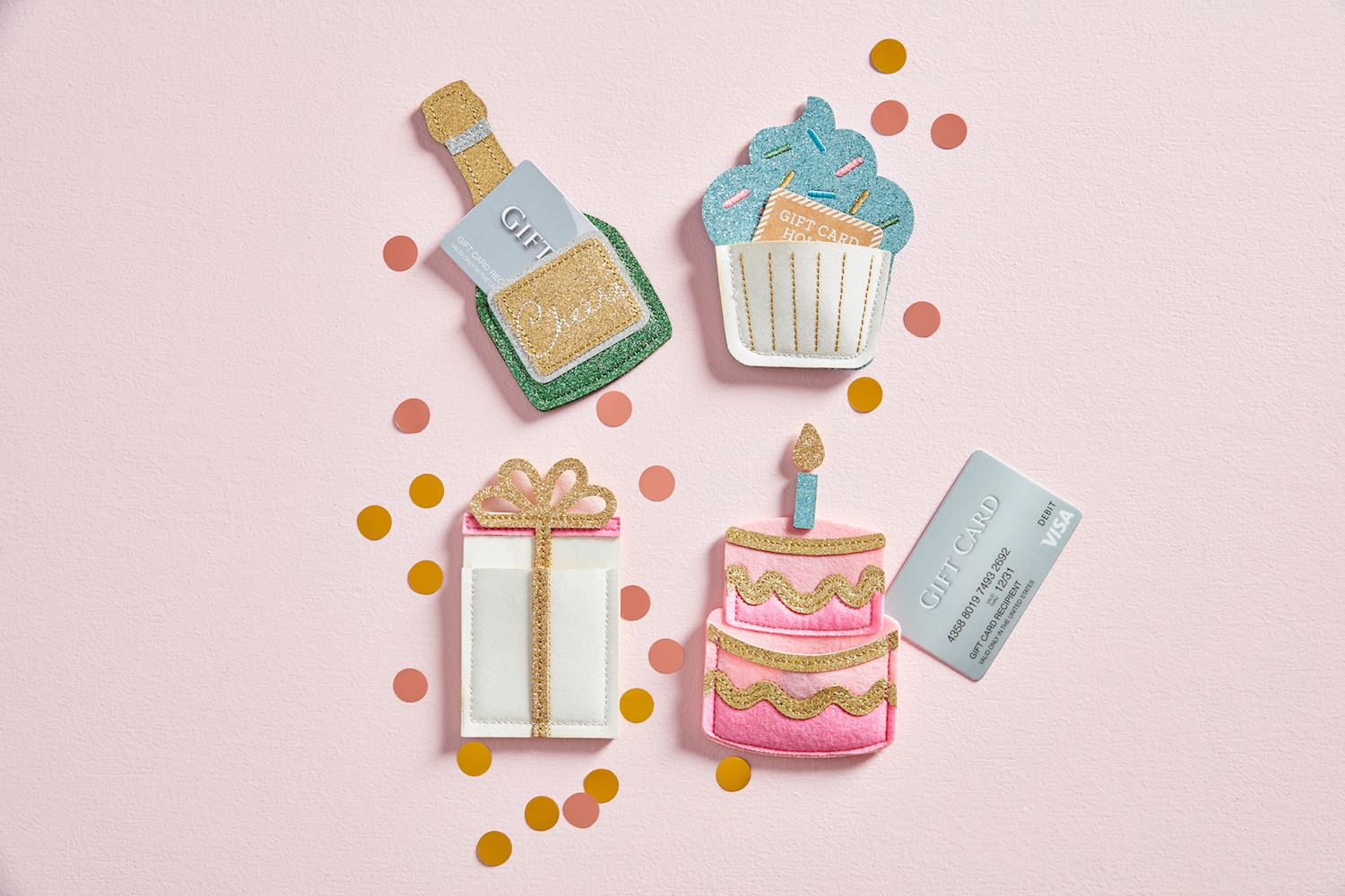 Felt gift card holders shaped like a champagne bottle, cupcake, gift box, and cake on a pink background with confetti