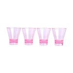 Four clear pink shot glasses with a flared top and thicker darker pink base aligned in a row on a white background