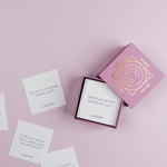 Lumitory Girls Night conversation card deck with open box and scattered prompt cards on a light purple background