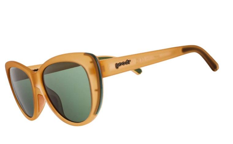 Goodr sunglasses with oversized cat-eye style translucent amber frames dark green tinted lenses Goodr logo on the temple and darker brown earpieces