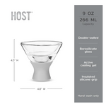 Product photo by HOST showcasing a double-walled borosilicate glass martini chiller with a light gray insulated silicone grip featuring active cooling gel and a 9-ounce capacity