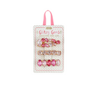 Product packaging by Mud Pie presents Glitzy Gems Rhinestone Hair Clips in a studio shot, featuring three distinct designs of pink and clear rhinestone clips with oval and marquise shapes, accented by a pink ribbon hanger