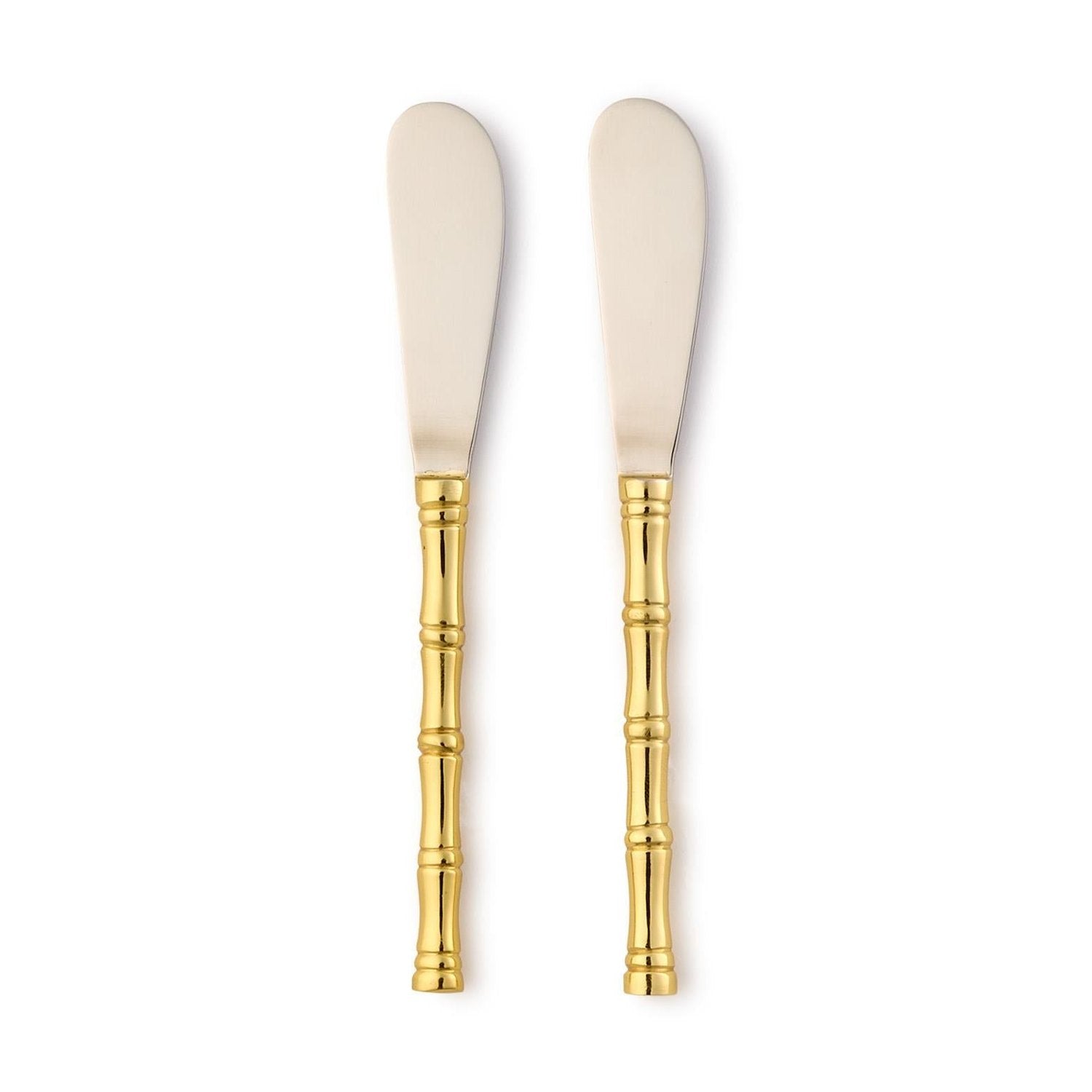 Polished stainless steel and gold-plated metal spreader knives displayed on a plain white background featuring textured bamboo-style handles and broad reflective rounded blades