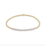 Gold bead stretch bracelet with a row of white pearls