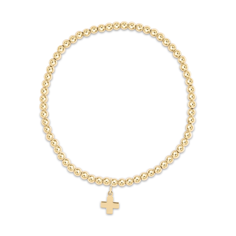 Gold beaded stretch bracelet with a small cross charm
