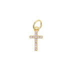 Gold jewelry charm depicting a small cross encrusted with sparkling clear cubic zirconia stones and a jump ring presented on a white background