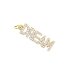 Gold-toned charm spelling DREAM in lowercase letters adorned with pavé-set clear sparkling stones and a small round bail