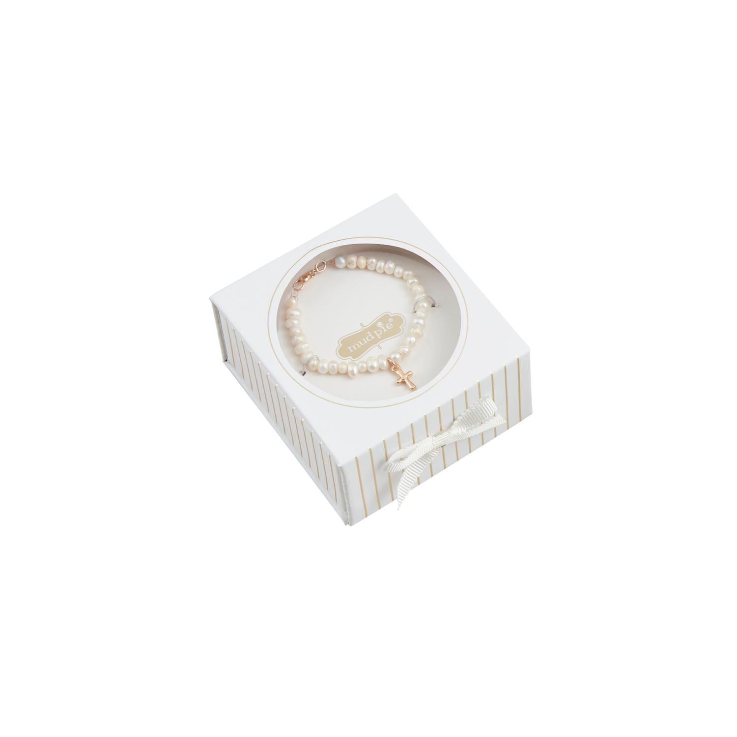 A faux pearl bracelet featuring a rose gold cross charm and Mud Pie brand tag displayed in a white gift box decorated with subtle gold stripes and a white ribbon bow