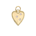 Gold heart pendant featuring three star-set clear gemstones and a beaded border