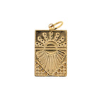 Gold charm with a square shape featuring a stylized sunburst motif with radiating lines and dotted textures