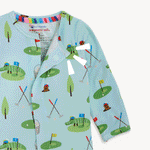 Fabric by magnetic me®, a light blue baby onesie featuring a playful golf course print with cartoon alligators and a beaver character, colorful golf flags, and magnetic closures