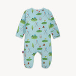 Light blue baby romper featuring a playful cartoon golf course pattern with green putting greens, colorful flags, crossed golf clubs, and whimsical alligators and gophers wearing golf hats