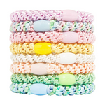 Product photography, L. Erickson stack of eight knitted elastic hair ties with matching oval beads in pastel shades including lavender, pink, yellow, and mint green