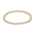 Bicolor beaded bracelet on a white background composed of alternating shiny gold and silver small spherical beads