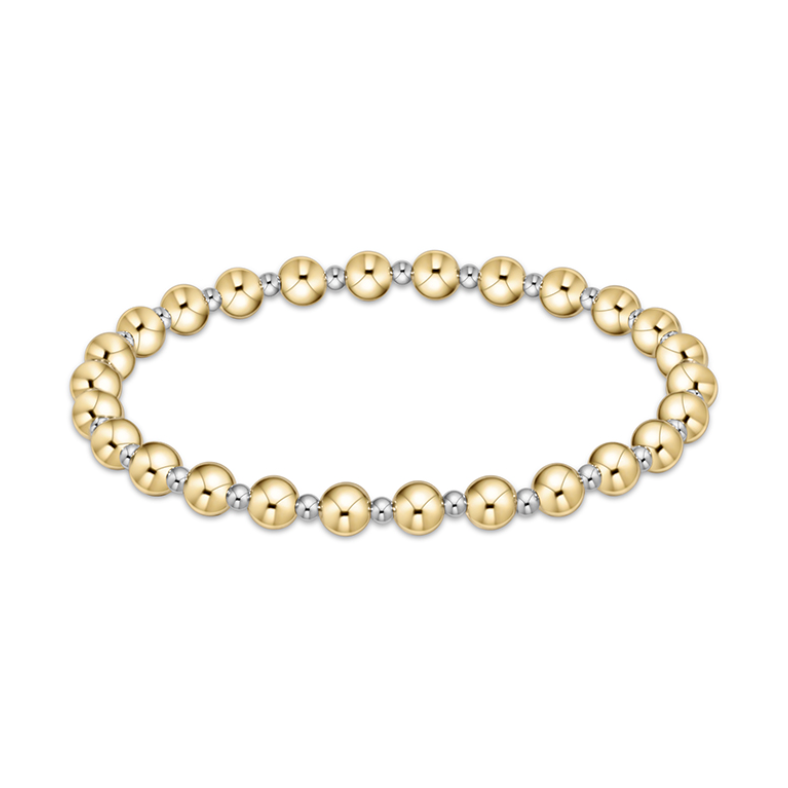 Beaded stretch bracelet featuring alternating polished larger gold beads and smaller silver beads