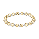 Product shot of an elegant stretch bracelet featuring alternating polished spherical gold and silver beads on a clean white background