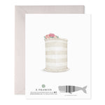 Back of greeting card featuring a watercolor illustration of a striped cake topped with pink roses