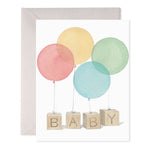 Watercolor illustration of four balloons tied to wooden blocks spelling out BABY