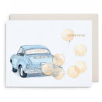 Watercolor illustration of a blue car with Just Married sign and balloons on a greeting card