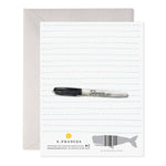 Greeting card back featuring blue lined paper design with a black marker illustration and whale barcode