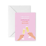 Greeting card with pink background and two hands toasting with champagne flutes