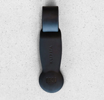 Black Klipsta hat clip on a speckled grey background