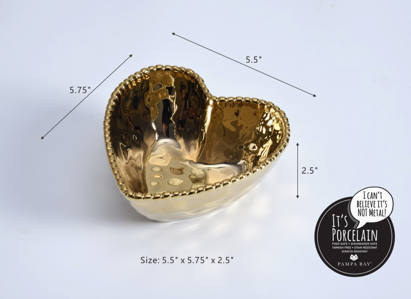 Pampa Bay porcelain heart-shaped bowl featuring a lustrous metallic gold hammered finish, a decorative beaded rim, and measuring 5.5 by 5.75 by 2.5 inches